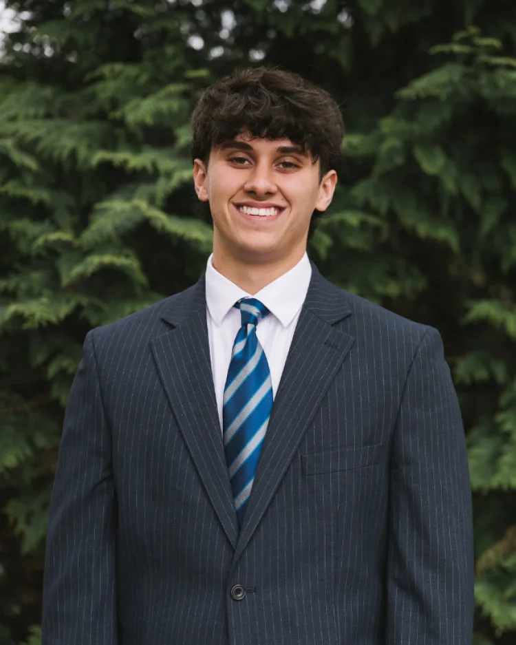 A sixth form student smiling