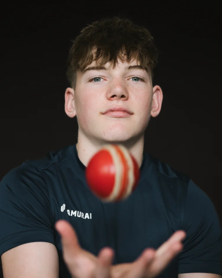 A student with a cricket ball